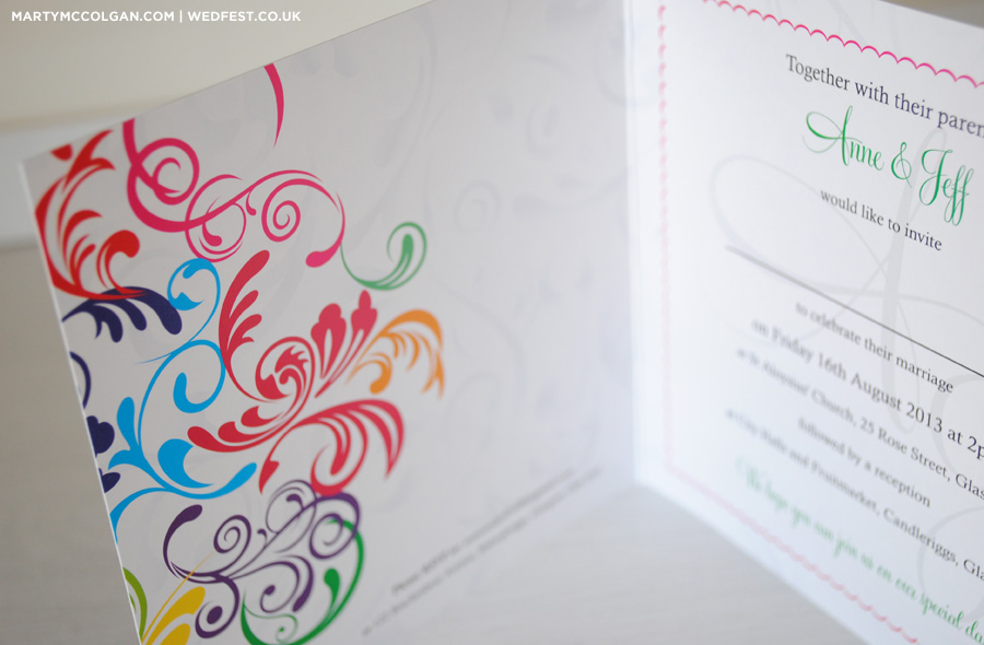 swirly rainbow coloured wedding invites